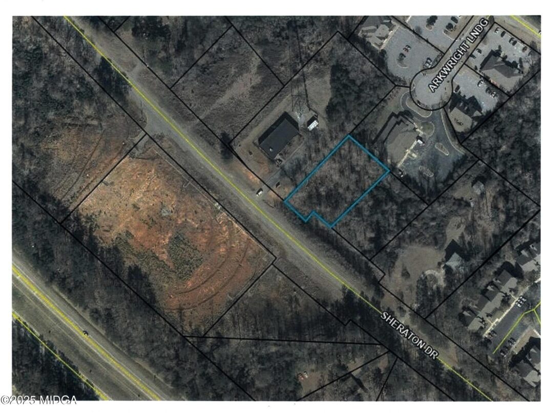 Aerial map with a blue outline marking a residential parcel along Sheraton Dr near a cul-de-sac and nearby buildings.