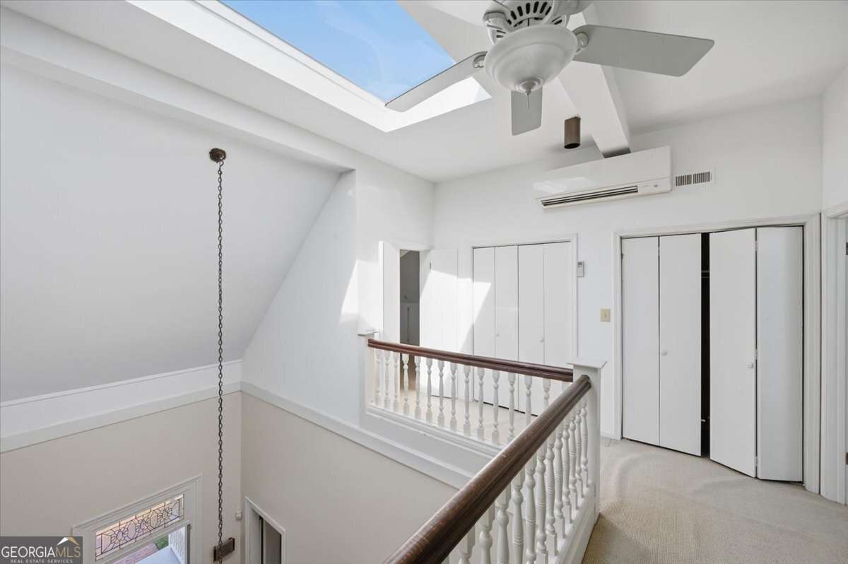 Interior image showing high ceilings, skylight, and architectural accents.
