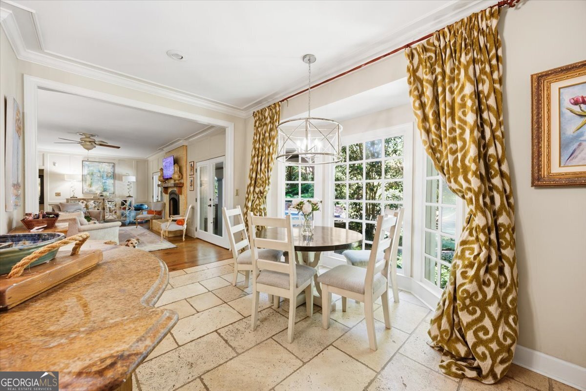 Breakfast nook and casual dining area at 4717 Brae Burn Lane featuring floor-to-ceiling windows, elegant designer drapery, natural light, and open flow into the luxury living spaces overlooking the private backyard.