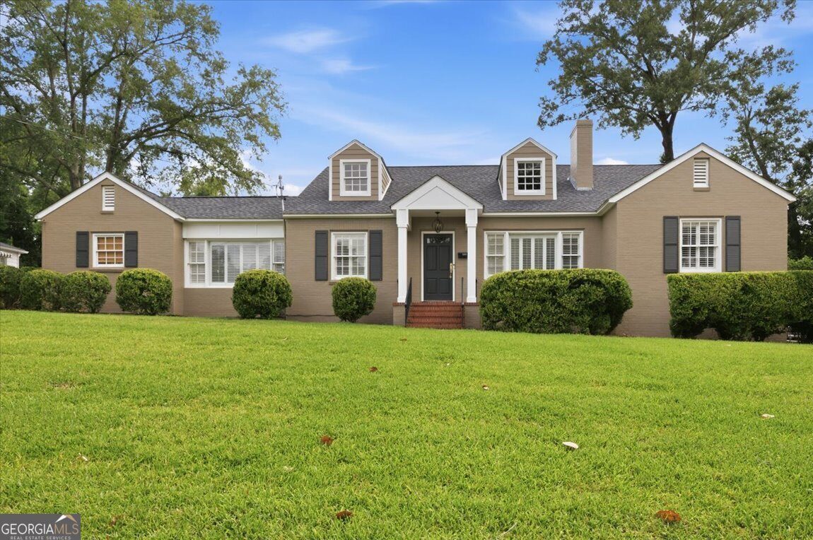Beautifully renovated brick home at 3561 Overlook Avenue in Midtown Macon featuring classic Southern charm, manicured landscaping, and timeless curb appeal.