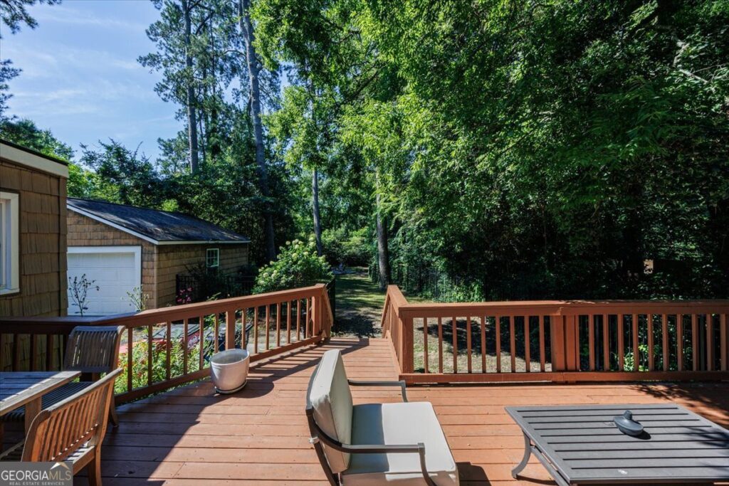 Spacious backyard deck overlooking the private fenced yard at 3118 Vista Circle in Macon with mature trees, detached two-car garage, and peaceful outdoor living space.
