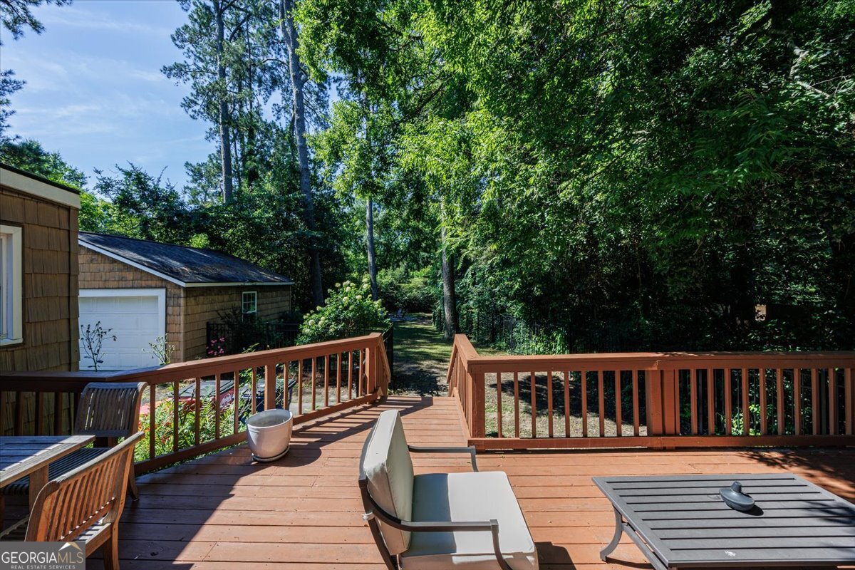 Spacious backyard deck overlooking the private fenced yard at 3118 Vista Circle in Macon with mature trees, detached two-car garage, and peaceful outdoor living space.