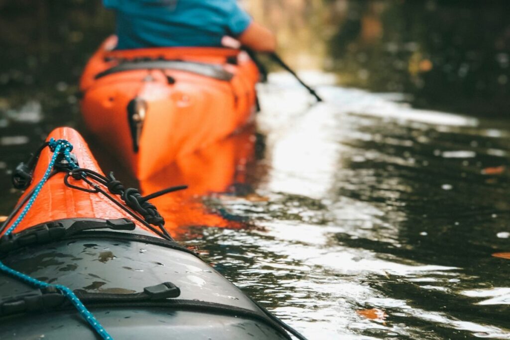 Family enjoying outdoor recreation on a peaceful river, representing the quality of life, family activities, and lifestyle opportunities that attract homebuyers to communities throughout Georgia.