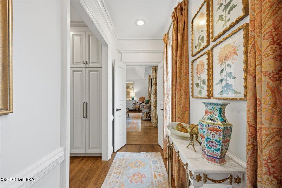 Elegant hallway with custom built-in cabinetry, hardwood floors, designer décor, and upscale finishes in a luxury Macon home