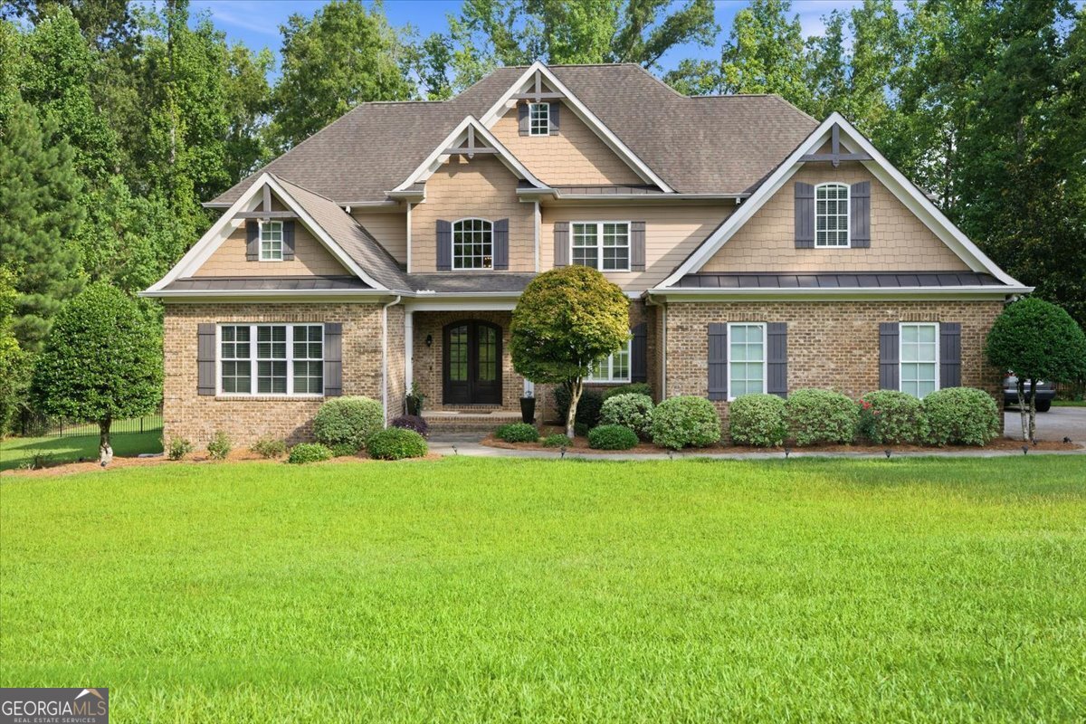 Front exterior of the luxury home at 309 Heydon Court in Camden North, Macon, GA, featuring all-brick construction, manicured landscaping, and traditional architecture.