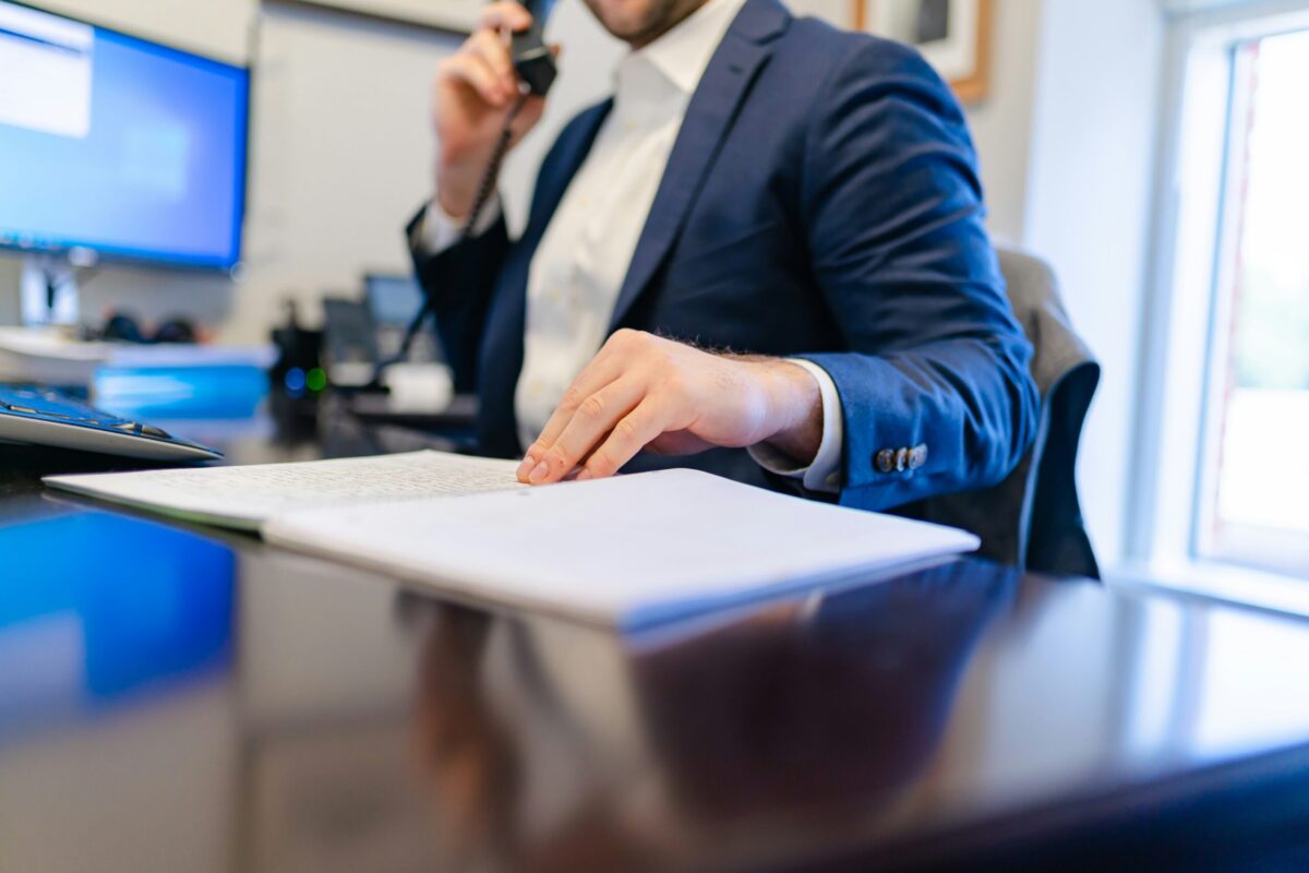 Mortgage lender reviewing home loan documents while speaking with a homebuyer about private mortgage insurance (PMI).
