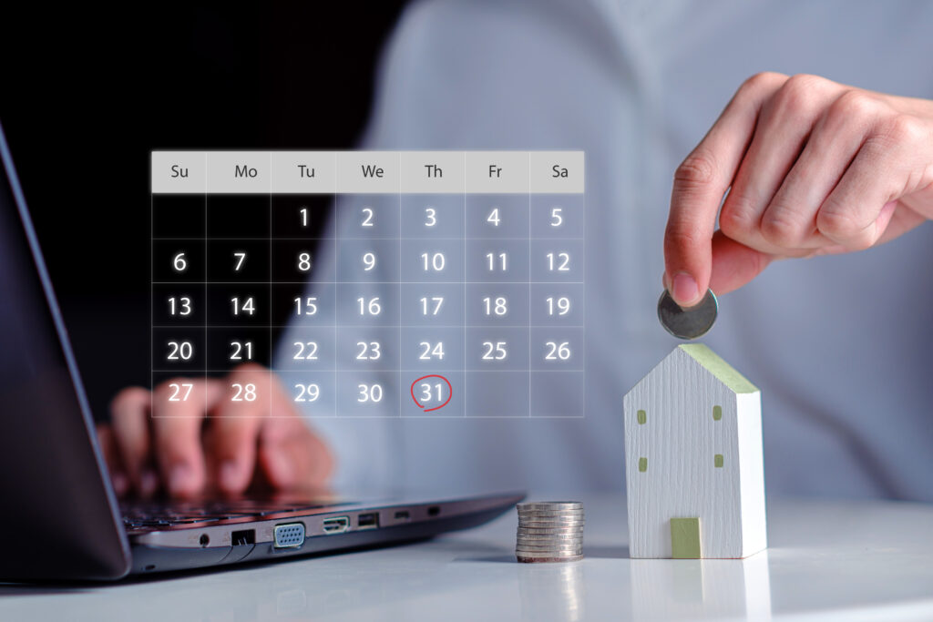 Homeowner planning tax savings with house model, calendar, and coins representing homeowner tax benefits and financial planning
