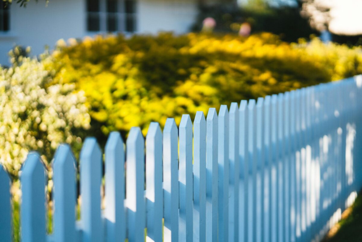 White picket fence in a quiet Macon neighborhood representing quality of life and the future of Macon real estate
