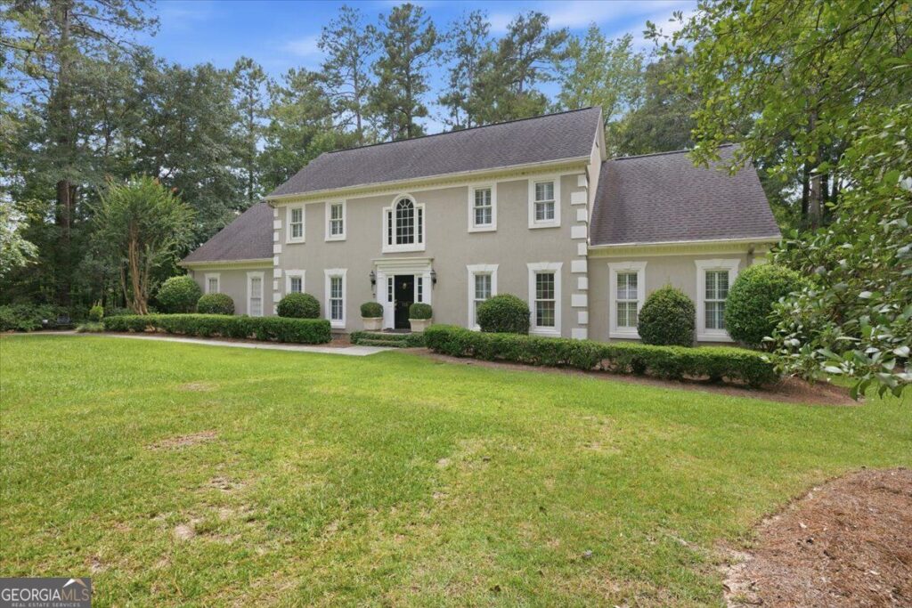 Front exterior of 118 Troon Way in St. Andrews, Macon, GA, featuring classic traditional architecture, mature landscaping, manicured lawn, and elegant curb appeal.