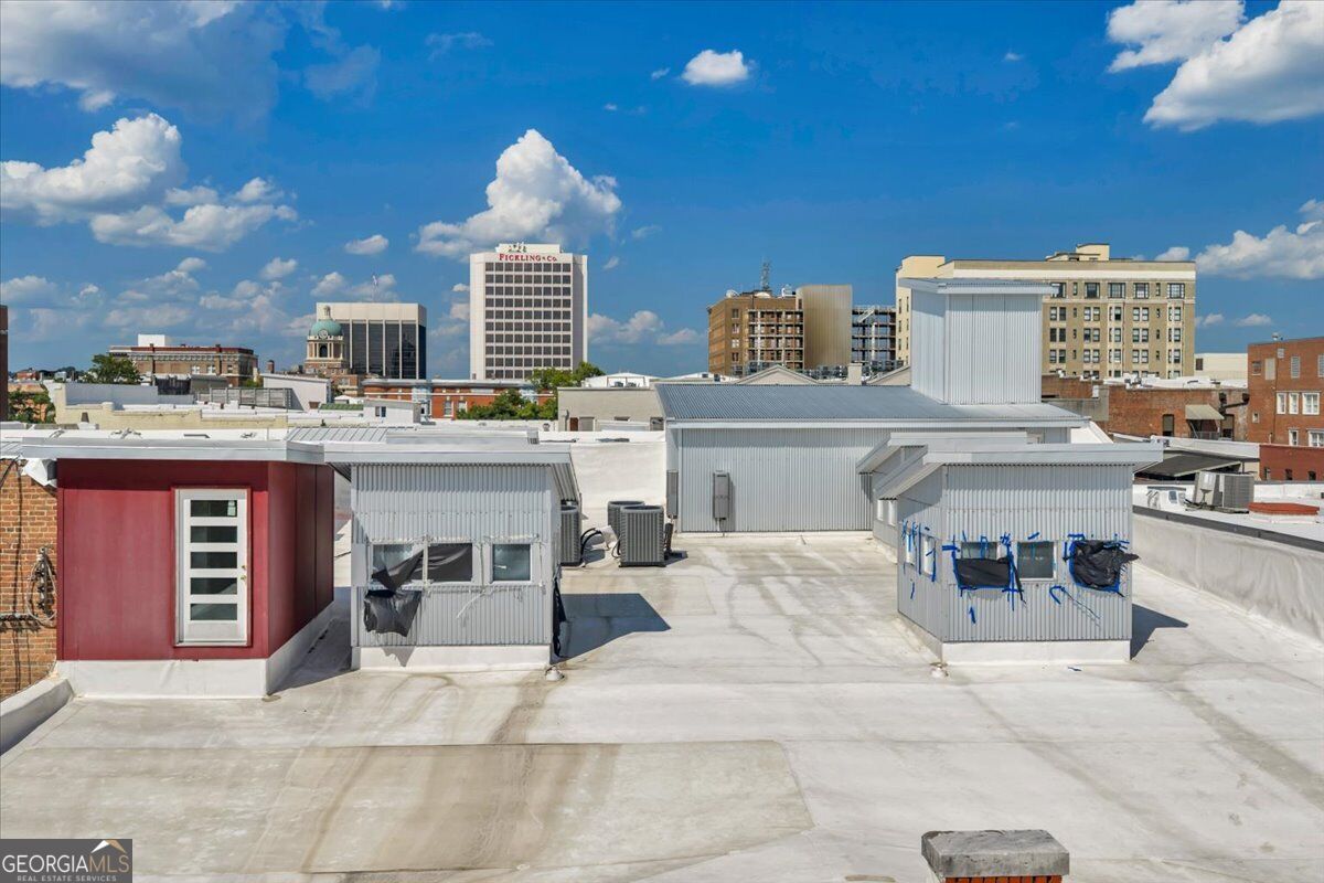 Rooftop view from 565 Poplar Street in Macon, GA, overlooking the surrounding historic downtown Macon skyline and city buildings.