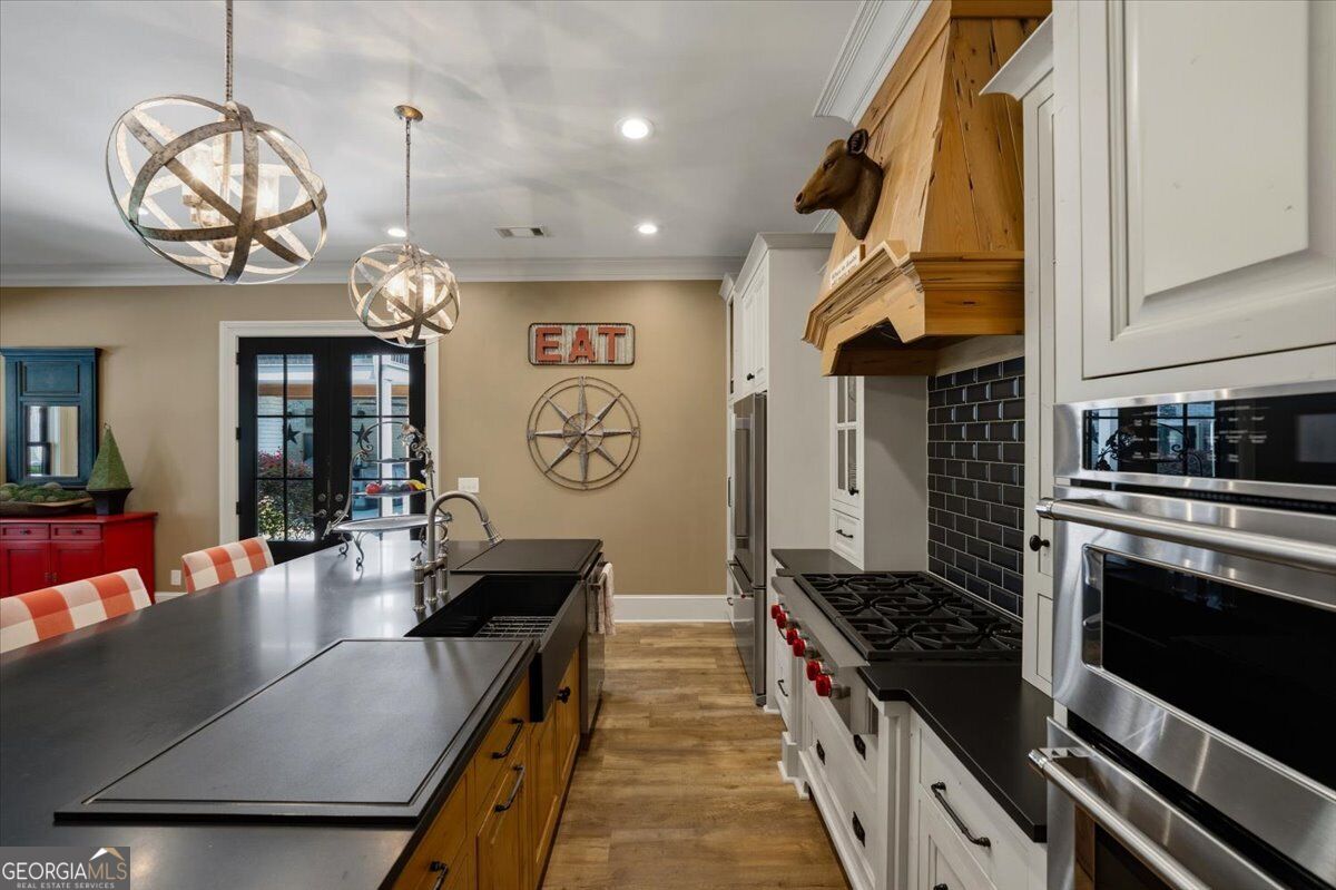 Guest house kitchen with large island and stainless steel appliances