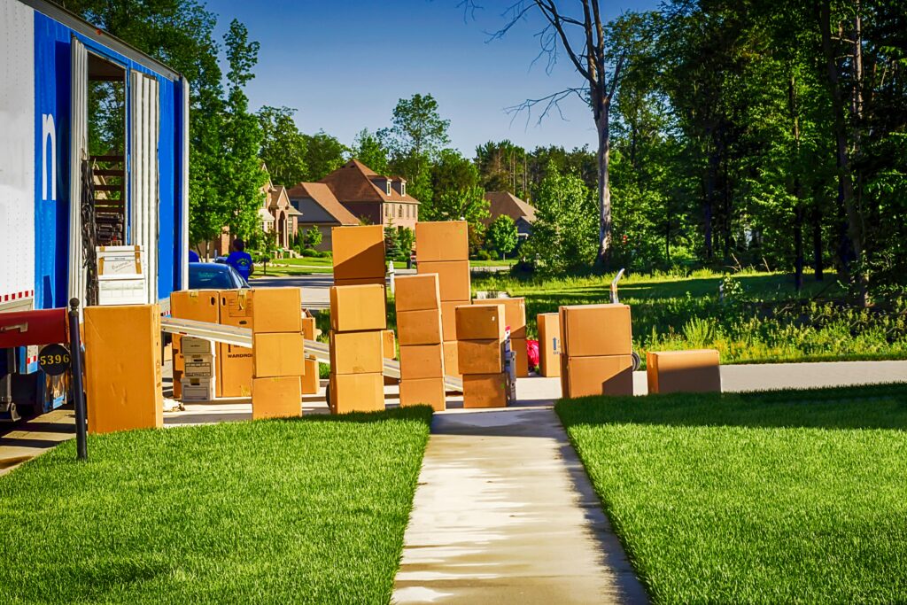 Moving From Florida to Middle Georgia | Joanna "JoJo" Jones REALTOR® - Joanna "JoJo" Jones Moving truck unloading boxes outside a home in a Middle Georgia neighborhood during a family relocation from Florida.