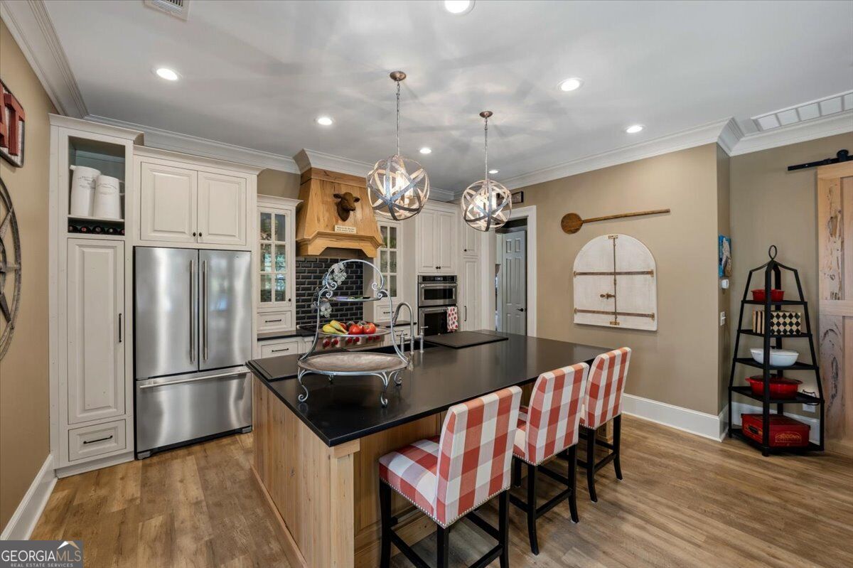 Guest house kitchen with large island and stainless steel appliances
