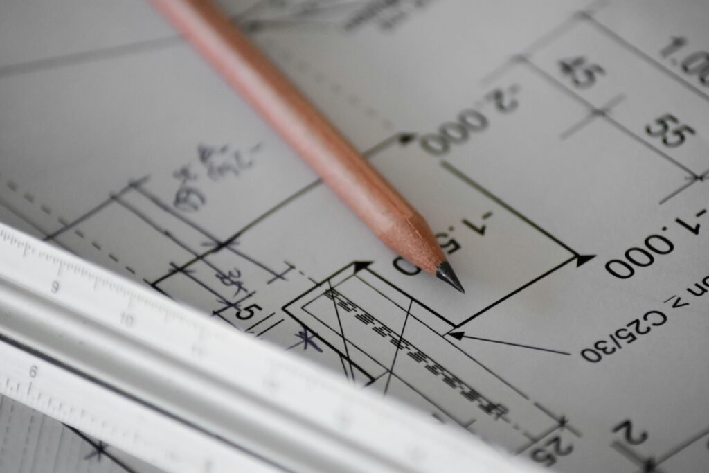 Architectural floor plan with pencil and ruler illustrating how to read home plans and room measurements