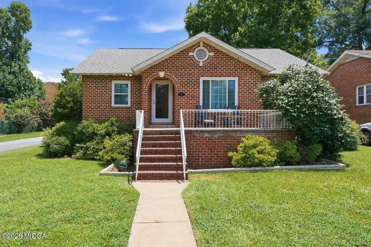 Brick home at 191 Holmes Avenue in Macon GA with a front porch and lawn