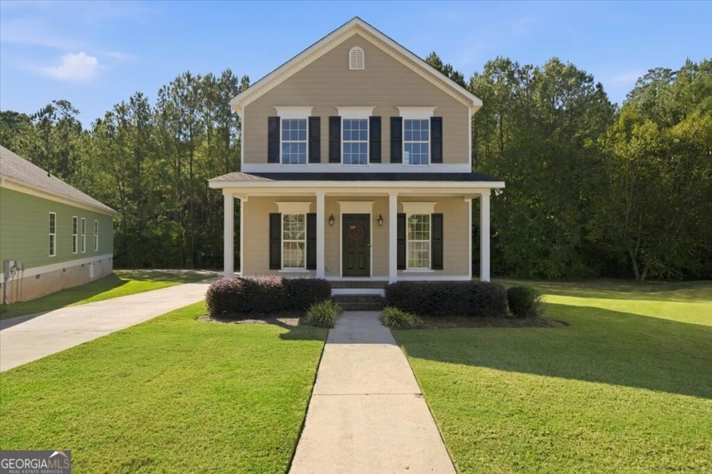 Two-story home with a covered front porch and landscaped yard at 369 Ivystone Drive in Macon, GA.