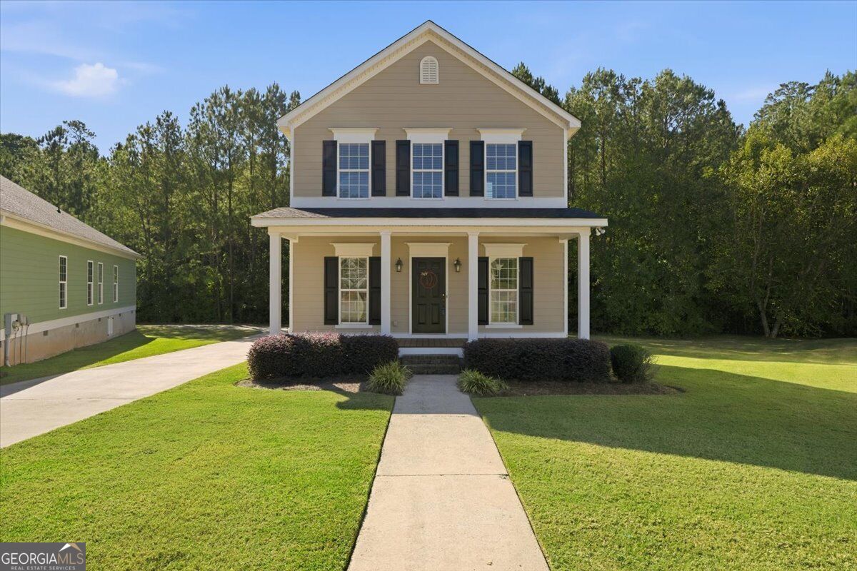 Two-story home with a covered front porch and landscaped yard at 369 Ivystone Drive in Macon, GA.