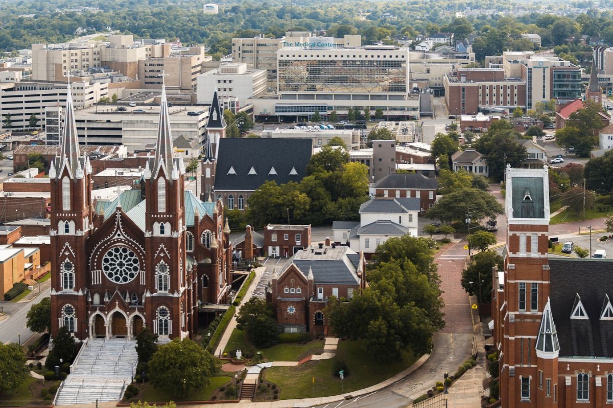 Relocating for Work in Macon GA – Downtown Macon Aerial View - Joanna "JoJo" Jones - Joanna "JoJo" Jones Aerial view of downtown Macon, Georgia, with historic churches and The Medical Center in the background